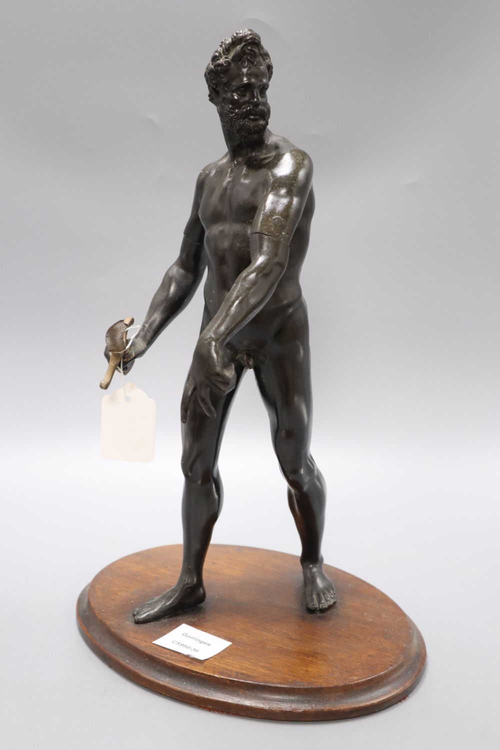After Giambologna. A bronze figure of Mars, 19th century, on oval wooden plinth (replacement sword), height 40cm